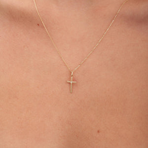 Introducing the Tiny 14K Solid Gold Diamond Cross Necklace, a delicate gold chain featuring a simple cross pendant adorned with a natural diamond at its heart. The elegant design beautifully stands out against a white background.