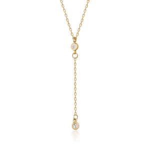 Introducing the 14K Solid Gold Diamond Lariat Y Necklace: This elegant piece showcases a delicate drop design, with two small natural diamonds encased in gold bezels. The diamonds are linked by a fine gold chain, creating a simple yet sophisticated appearance. The pendant is designed to hang vertically at the center.