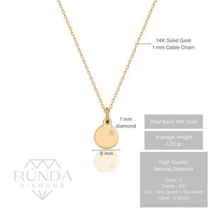 The 14K Solid Gold Round Disc Diamond Necklace showcases a smooth gold pendant with a subtle diamond accent on a delicate chain, artfully presented against a white background.