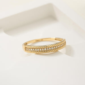 A 14K solid gold ring with a twisted edge design, highlighted by a row of natural, sparkling diamonds in the center.