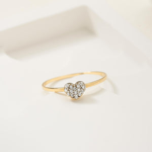 The 14K Solid Gold Natural Diamond Heart Engagement Ring showcases a heart centerpiece with small natural white diamonds, set elegantly on a thin band against a plain white backdrop.