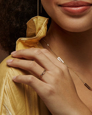 The 14K Solid Gold Paperclip Unique Statement Ring from the Harmony Collection showcases interconnected rectangular links with a polished gold finish. Expertly handcrafted using Runda's sustainable methods, this piece is stamped to confirm its 14K solid gold purity and ethical elegance.