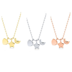 A set of three hypoallergenic necklaces featuring heart, star, and crescent moon charms with chains includes one in lustrous 14K gold, one in shimmering silver, and one in radiant rose gold. Each necklace is presented on a pristine white background.