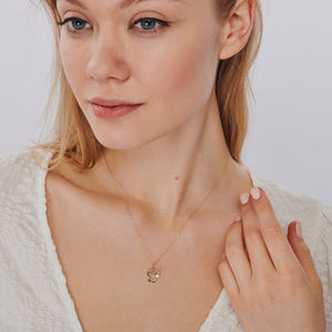 The 14K Gold Diamond Butterfly Necklace showcases a delicate design featuring a butterfly pendant with an open-wing style. A small, sparkling diamond adorns one wing, elegantly hanging from a fine gold chain.