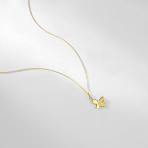 Introducing the 14K Gold Butterfly Necklace, a hypoallergenic piece crafted with a delicate chain and adorned with a small, lustrous butterfly pendant that hangs gracefully at the center. The sleekly designed butterfly features gently open wings, adding to its elegant charm.