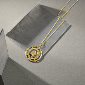 Introducing the 14K Gold Compass Necklace from RundaJewelryUs, featuring a circular pendant with an exquisite sunburst design at its center. This elegant piece is adorned with the letters N, E, S, and W to indicate cardinal directions, making it an ideal travel accessory for adventure seekers or a perfect graduation gift.