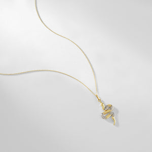 The 14K Gold Snake Necklace for Women by RundaJewelryUs features a pendant in the form of a stylized snake. Embellished with small jewels, it offers an elegantly intricate design that captivates the eye.