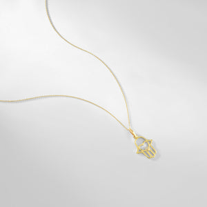 The 14K Gold Hamsa Pendant Necklace elegantly displays a Hamsa pendant with an open heart design at its center, highlighted by a sparkling lab-grown diamond. The delicate chain adds to the refined allure of this beautiful piece.