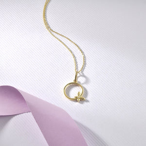 Introducing the 14K Gold Butterfly Necklace, a finely crafted piece showcasing a slender chain adorned with a circular pendant. The pendant features an elegant, small butterfly design attached at the bottom. Set against a plain white background, this exquisite and hypoallergenic jewelry piece exudes simplicity and elegance.