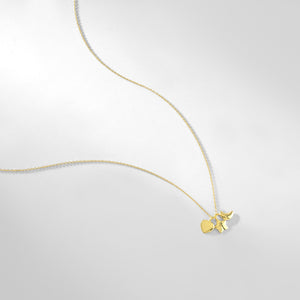 A set of three hypoallergenic necklaces featuring heart, star, and crescent moon charms with chains includes one in lustrous 14K gold, one in shimmering silver, and one in radiant rose gold. Each necklace is presented on a pristine white background.