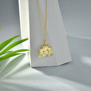 A delicate 14K gold necklace featuring a pendant of a cat family, expertly crafted in shining metal.