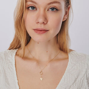 The 14k Solid Gold Tree of Life Y Necklace by RundaJewelryUs is a minimalist and elegant piece, featuring a delicate thin chain with a small circle pendant. A tree of life charm hangs below, and the addition of a tiny embedded gemstone on one side adds subtle sophistication to the design.