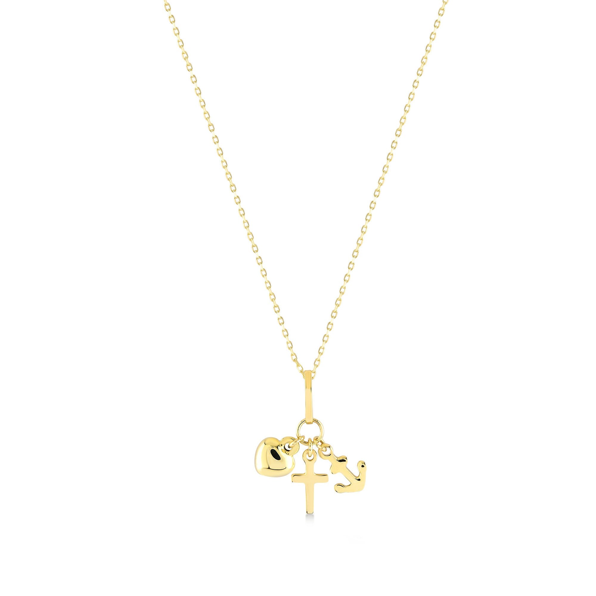 The Faith Hope Love Necklace is a 14K Gold Necklace adorned with a Cross Charm Pendant along with heart and anchor charms, representing faith, hope, and love. Each charm gracefully hangs from a delicate gold chain set against a pristine white background.