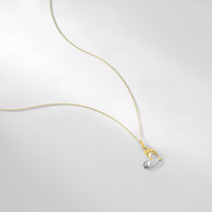 A delicate 14K solid gold necklace featuring a pendant shaped like a graceful dolphin, crafted in striking yellow-white gold and silver. The design is elegant and minimalistic, set against a white background.