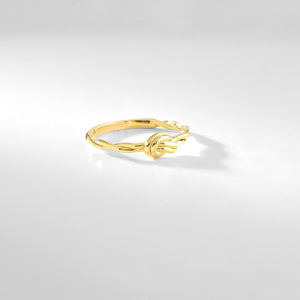 The 14k Solid Gold Knot Ring features a twisted band and is set against a white background, highlighting its simple and elegant design. Perfect as a minimalist stackable gold ring, it effortlessly captures timeless beauty.