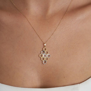 Experience the elegance of the 14K Solid Gold Honeycomb Necklace by RundaJewelryUs, featuring a geometric pendant with interconnected hexagonal shapes in both gold and silver tones. This exquisite piece perfectly captures a honeycomb pattern, beautifully blending nature's charm with modern design.