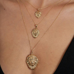 Introducing the 14K Gold Lion Head Necklace, an exquisite piece of animal jewelry featuring a finely detailed lion head pendant with an intricate mane. This stunning necklace is elegantly suspended from a delicate chain, enhancing any ensemble with its elegance and charm.