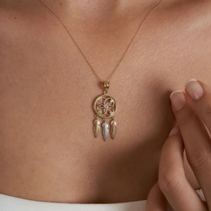 Introducing the 14K Gold Dreamcatcher Necklace by RundaJewelryUs, crafted from real 14K gold and featuring a beautiful flower design adorned with small gems. Three feather-shaped charms in gold, silver, and bronze dangle elegantly beneath. This hypoallergenic piece is ideal for those with sensitive skin.