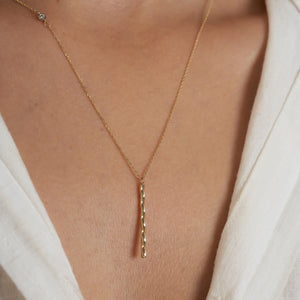 The RundaJewelryUs 14K Gold Twisted Vertical Bar Diamond Necklace highlights a delicate solid gold chain featuring a small, genuine diamond pendant on one side, paired with a textured vertical gold bar pendant that gracefully hangs in the center against a plain white background.