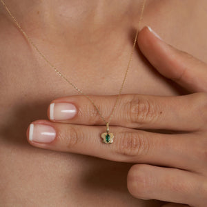 The 14K Gold Emerald Butterfly Necklace features a graceful butterfly-shaped pendant centered with a green marquise-cut gemstone. The delicate chain, crafted from 14K gold, enhances its shiny finish and embodies a minimal positivity charm.