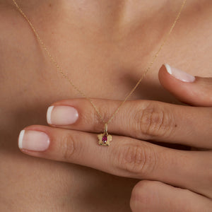 Presenting the 14K Gold Tiny Ruby Butterfly Necklace, this piece features a marquise-cut pink gemstone at the center of its butterfly-shaped pendant. The necklace boasts a delicate chain that completes its graceful design, exemplifying sustainable jewelry craftsmanship against a plain white backdrop.