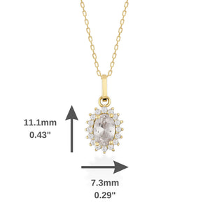 The 14K Gold Oval Cubic Zirconia Gemstone Necklace showcases a delicate design with an oval-shaped pendant adorned with a prominent cubic zirconia gemstone. Smaller stones encircle the centerpiece, creating a dazzling effect against a simple white backdrop.