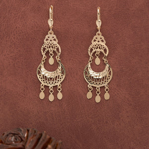 The 14K Real Gold Dream Catcher Earrings are showcased on a white background, boasting elaborate cutout designs with crescent shapes and dangling round elements. These lightweight, hypoallergenic earrings are ideal for sensitive skin.