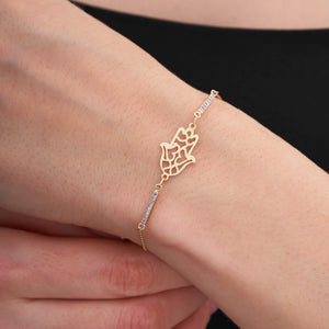 The 14K Gold Hamsa Hand Charm Protection Bracelet is an exquisite piece, featuring a lattice-detailed hamsa hand charm surrounded by small, sparkling gemstones on a delicate chain. This elegant Good Luck Kabbalah Jewelry piece offers both protection and sophistication, secured with a lobster clasp closure.