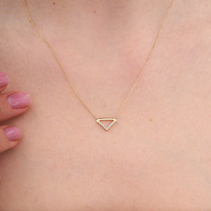 The 14K Gold Triangle Symbol Pendant Necklace by RundaJewelryUs features a triangle charm adorned with a row of small, sparkling diamonds on one side. The delicate chain enhances the minimalistic and elegant design of the centrally hanging pendant.