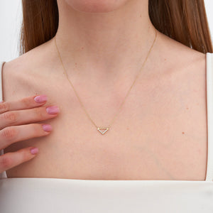 The 14K Gold Triangle Symbol Pendant Necklace by RundaJewelryUs features a triangle charm adorned with a row of small, sparkling diamonds on one side. The delicate chain enhances the minimalistic and elegant design of the centrally hanging pendant.