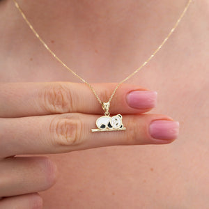 The 14K Gold Panda Necklace perfectly embodies the charm of animal-themed jewelry, featuring a panda with white and black enamel accents resting on a gold branch. Its delicate chain makes it a wonderful gift for her.