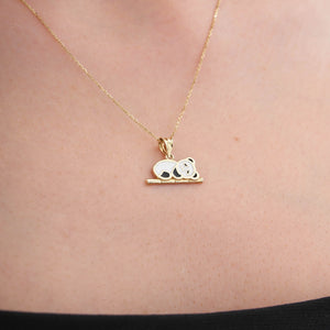 The 14K Gold Panda Necklace perfectly embodies the charm of animal-themed jewelry, featuring a panda with white and black enamel accents resting on a gold branch. Its delicate chain makes it a wonderful gift for her.