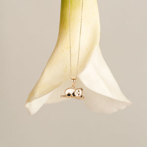 The 14K Gold Panda Necklace perfectly embodies the charm of animal-themed jewelry, featuring a panda with white and black enamel accents resting on a gold branch. Its delicate chain makes it a wonderful gift for her.