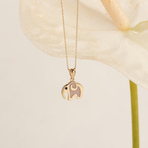 The 14K Solid Gold Elephant Necklace showcases a delicate chain and an elephant-shaped pendant, symbolizing good luck. Its minimalist design is enhanced by a subtle black eye detail, adding both elegance and whimsy to this refined piece of animal jewelry, all set against a pristine white background.