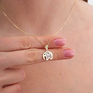 The 14K Solid Gold Elephant Necklace showcases a delicate chain and an elephant-shaped pendant, symbolizing good luck. Its minimalist design is enhanced by a subtle black eye detail, adding both elegance and whimsy to this refined piece of animal jewelry, all set against a pristine white background.