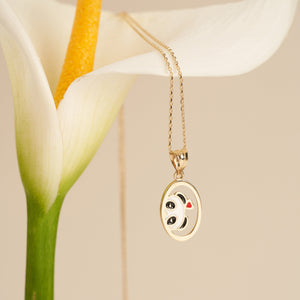 Experience the charm of the 14K Gold Lover Panda Necklace, showcasing a pendant with an adorable panda face in vibrant black, white, and gold tones. A petite red heart embellishes its cheek, gracefully hanging from an elegant gold link chain. The perfect accessory for fans of Cute Animal Jewelry, set against a simple white backdrop.