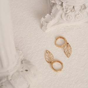 Experience the sophistication of the 14K Gold Leaf Dangle Earrings, featuring elegant leaf-shaped charms and intricate cut-out designs. This exquisite piece is crafted using sustainable methods, adding a unique touch to your handmade gold jewelry collection.