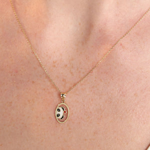 Experience the charm of the 14K Gold Lover Panda Necklace, showcasing a pendant with an adorable panda face in vibrant black, white, and gold tones. A petite red heart embellishes its cheek, gracefully hanging from an elegant gold link chain. The perfect accessory for fans of Cute Animal Jewelry, set against a simple white backdrop.