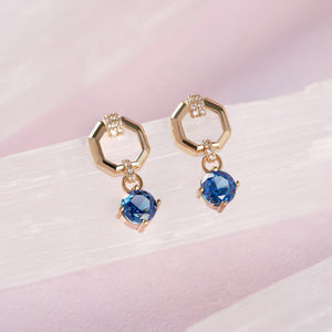 14K Real Gold London Blue Topaz Earrings feature hexagonal loops embellished with small white gemstones and dangling round-set London Blue Topaz.