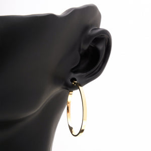 The 14K Gold Round Hoop Earrings from the Harmony Collection by RundaJewelryUs are showcased. One earring is pictured facing forward, accentuating its circular form, while the other is displayed from the side, highlighting its sleek profile and contemporary design.