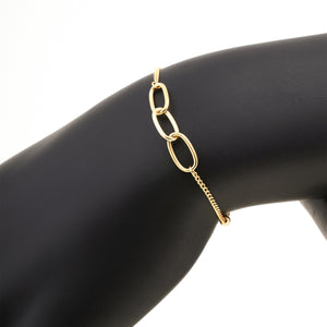 The 14K Solid Gold Triple Interlocking Unity Bracelet from the Harmony Collection boasts three prominent interlocking links at the center, accompanied by small circular charms and an adjustable clasp. Model No X5B201376 is distinguished by its intricate chain and charm detailing, featuring a hypoallergenic design ideal for those with sensitive skin.