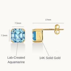 Presenting a stunning pair of 14K Gold Aquamarine Stud Earrings from Runda Jewelry. One earring is displayed from the front, emphasizing the vibrant aquamarine gemstone, while the other is shown from the side to beautifully showcase its elegant gold setting and post.