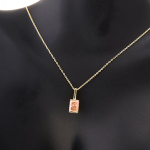 The 14K Gold Pink Rose Quartz Necklace features a rectangular pink rose quartz pendant on a delicate 14K solid gold chain, symbolizing self-love, and is showcased against a white background.