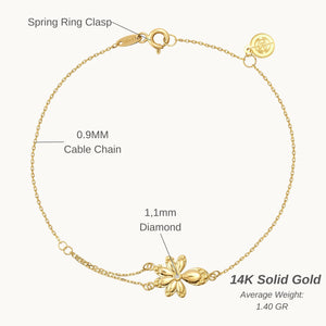 The 14K Solid Gold Diamond Leaf Bracelet from the Chloris Collection showcases a delicate chain link design with a captivating floral charm at its center, making it an ideal bridesmaids' gift for a forest wedding. The simple spring ring clasp and small circular tag provide an elegant touch against the plain white background.