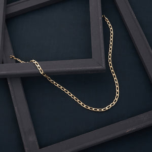 The 14K Real Gold Cuban Curb Link Chain Necklace, featuring elongated links, is showcased against a plain white background. It forms a U shape, emphasizing its simple yet elegant design—ideal for both men and women.