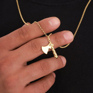 The 14K Solid Gold Axe Pendant Necklace for Men showcases a captivating axe pendant, complete with a textured handle and smooth blade, elegantly hanging from a gold chain.