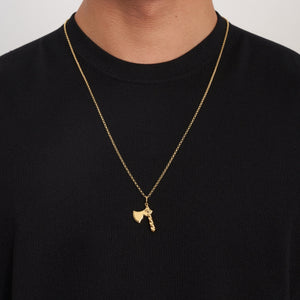 The 14K Solid Gold Axe Pendant Necklace for Men showcases a captivating axe pendant, complete with a textured handle and smooth blade, elegantly hanging from a gold chain.