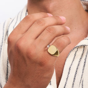 The 14K Solid Gold Plain Polished Signet Ring For Men, featuring a sleek, flat top surface against a white background, exemplifies timeless men's jewelry.