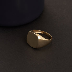 The 14K Solid Gold Plain Polished Signet Ring For Men, featuring a sleek, flat top surface against a white background, exemplifies timeless men's jewelry.