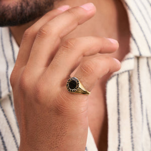 Discover the 14K Solid Gold Black Enamel Greek Key Ring for Men, a modern and sleek piece featuring a black circular face adorned with an intricate labyrinth meander pattern around the edge. This contemporary design adds a fresh twist to the classic signet ring style.